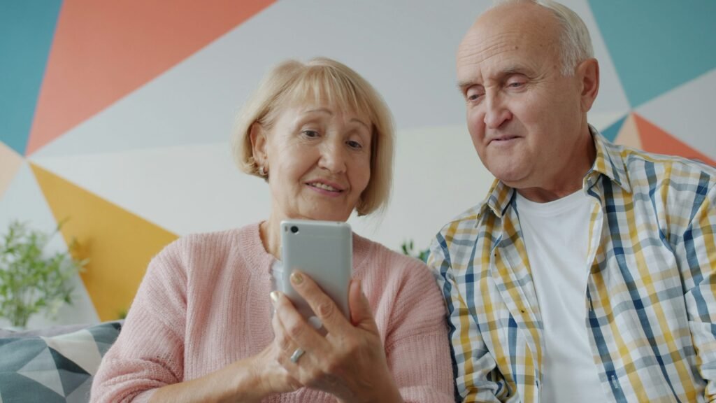 Older couple reviewing information on a smartphone together at home