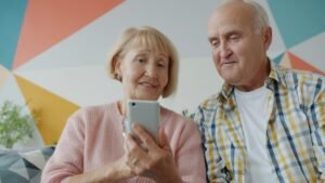 Older couple reviewing information on a smartphone together at home